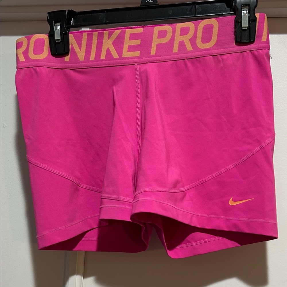 Nike Pro Women's Bright Pink Athletic Shorts with Orange Swoosh